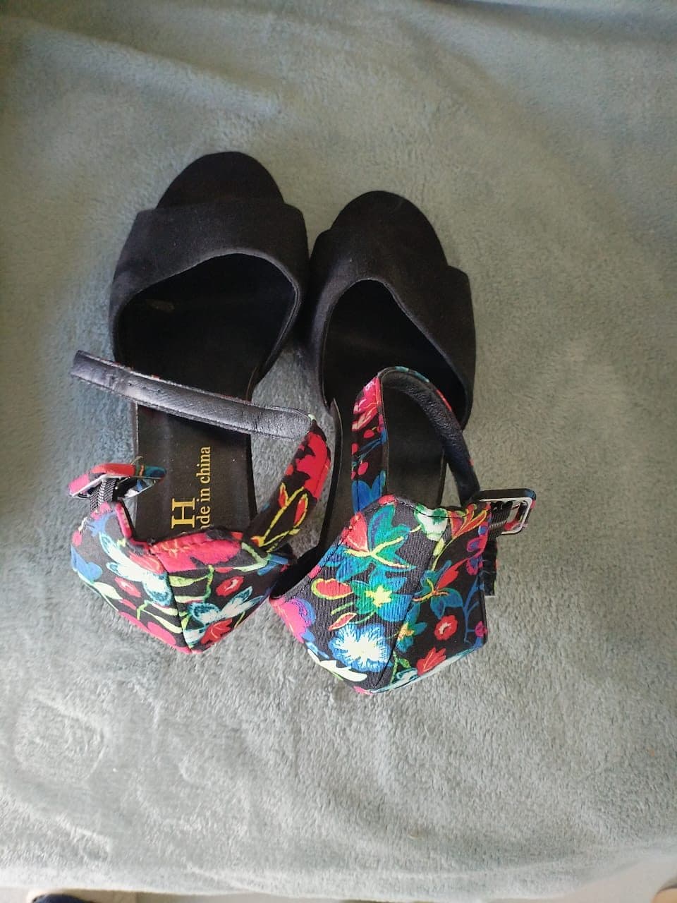 Black suede peep-toe platform heels with floral heel