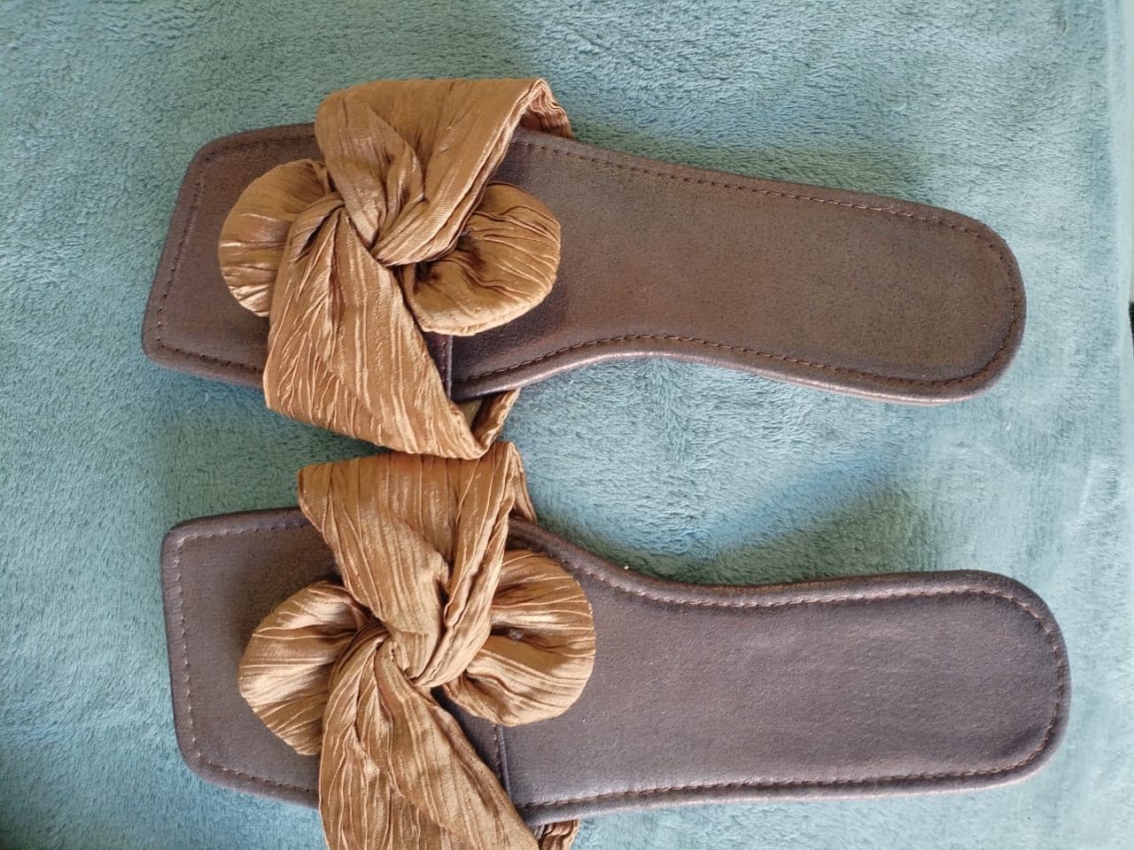 Gold-bronze knotted satin flat slide sandals